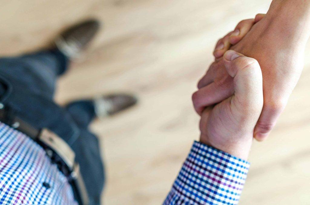 a firm handshake between two parties