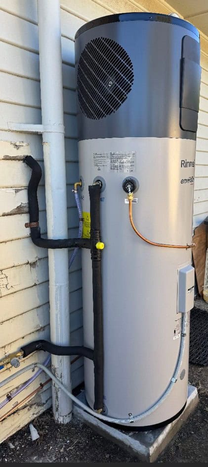 hot water system installed outside on side of house